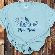 a t - shirt with the words new york on it and fireworks in the sky