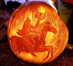 a carved pumpkin with an image of a horse and rider on it's face