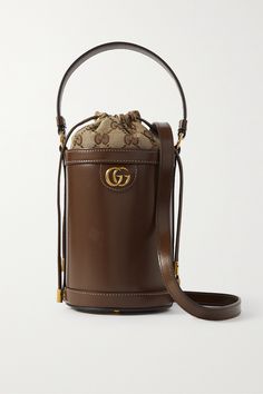 Gucci's beloved 'Ophidia' collection is defined by timeless silhouettes and signature details. Crafted in Italy from smooth leather, this bucket bag is embellished with the iconic gold-tone 'GG' hardware and lined with a monogrammed canvas-jacquard pouch that secures with drawstring ties. Carry yours by the top handle or shoulder strap. Luxury Miu Miu Shoulder Bag For Daily Use, Luxury Baguette Bag With Multiple Compartments For Daily Use, Luxury Trendy Baguette Bag For Party, Luxury Leather Bucket Bag, Luxury Baguette Bag With Metal Hardware For Women, Luxury Chic Baguette Bag For Daily Use, Luxury Elegant Satchel With Single Shoulder Strap, Luxury Vintage Rectangular Baguette Bag, Trendy Accessories Bag