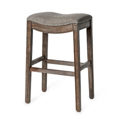 the backless stool is made from wood and has a gray upholstered seat