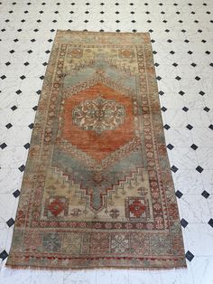 an old rug is laying on the floor