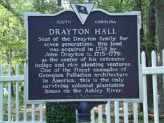 a sign in front of a white picket fence that says drayton hall, seat of the drayton family for seven generations