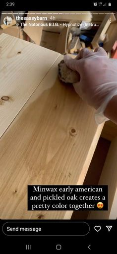 a person wearing gloves is cutting wood with a knife