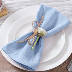 a white plate topped with a blue napkin