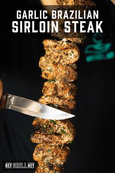 someone is cutting up some meat on a skewer with the words garlic brazilian sirlon steak