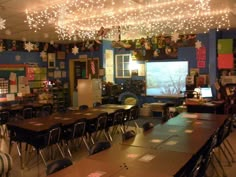 an empty classroom is decorated with christmas lights