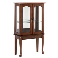 a wooden cabinet with glass doors on the top and bottom shelf, in front of a white background