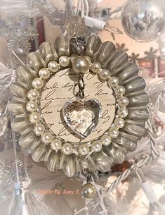 an ornament with a heart in the center surrounded by ornaments