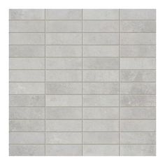 a white tile wall that has been made out of concrete blocks and is lined with small squares