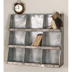 an old metal shelf with books and a clock on the wall next to it,