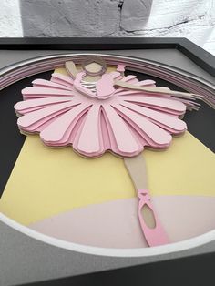 there is a clock with a pink ballerina on it