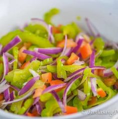 a white bowl filled with lots of veggies