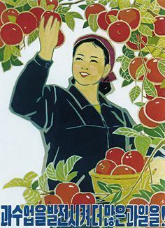 a woman is holding up an apple in front of some fruit on the tree,