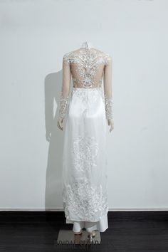 the back of a white wedding dress on display