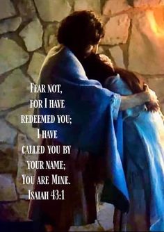 a man and woman embracing each other in front of a stone wall with the words, fear not for i have redeem you