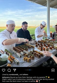 people are serving themselves food at an outdoor event