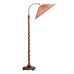 a wooden floor lamp with an umbrella shade on it's top and bottom arm