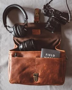 a brown bag with headphones and a camera