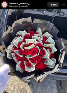 a bouquet of roses is in the back of a car with money sticking out of it