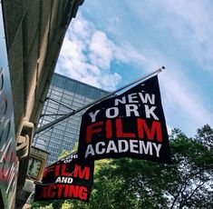 two signs hanging off the side of a building advertising film and acting in new york