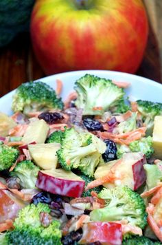 broccoli salad with apples and cranberries in a white bowl