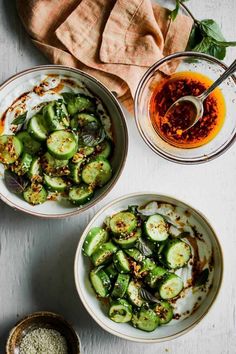 two bowls filled with cucumbers and spices