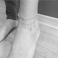 a woman's foot with a star ankle tattoo on the left side of her leg