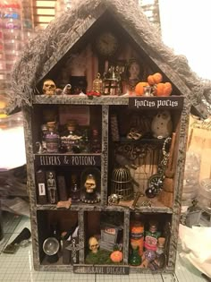 a doll house with lots of halloween decorations