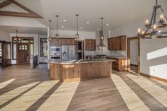 a large open floor plan with wood floors and wooden beams on the ceiling is shown