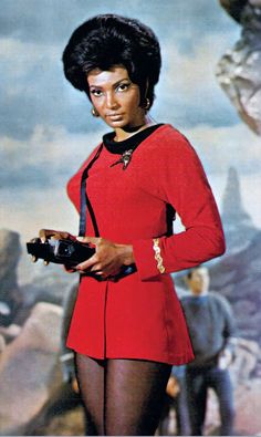 a woman in red uniform holding a camera