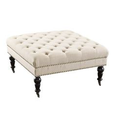 the foot stool is upholstered with buttons