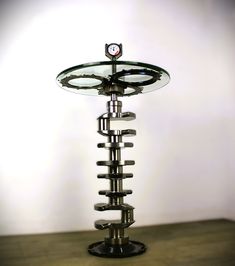 a glass and metal object on top of a wooden table