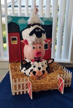 a cake made to look like farm animals on top of each other in a hay box