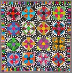 a colorful quilt with many different designs on it