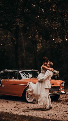 a bride and groom kissing in front of an old car