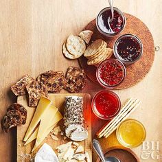 a wooden table topped with cheese and crackers