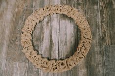 a wreath made out of jute on a wooden floor