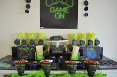 a game on party with neon green decorations and black table cloths, cups, and plates