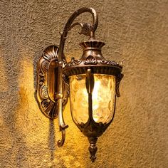 an old fashioned wall light on the side of a building