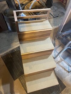 a set of stairs made out of plywood and wood with carpet on the floor