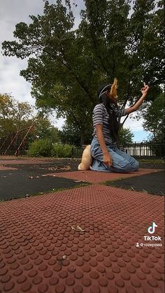 a man sitting on the ground next to a dog