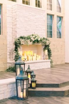 candles are lit on the steps in front of a fireplace