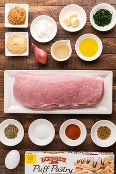 ingredients to make an appetizer laid out on a cutting board, including meat and seasonings