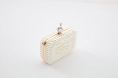 Handmade pearl clutch, perfect for any Special Occasions, such as chilly wedding day I Christmas Show I Vintage wedding shoot I Formal Evenings and more.   This beautiful clutch is a perfect match with our stunning pearl wedding shoes(go to our shop to have a look if you still have not met them yet), classic will never out of fashion. All pearls are added by our handcraft one by one with love and care.  --Measurements:15cm*11cm*5.5m  --Color: Creamy white  -- Weight: 425Gram --  Chain length: 12 Luxury Pearl Clutch For Formal Occasions, Formal White Bags With Pearl Handle, Luxury Pearl Clutch For Events, Elegant Pearl Evening Bag For Events, Formal Gold Clutch With Pearl Material, Formal Pearl White Evening Bag, Pearl Evening Bag With Pearl Handle, Pearl Evening Bag With Pearl Handle For Wedding Guest, Luxury Pearl Evening Bag For Events