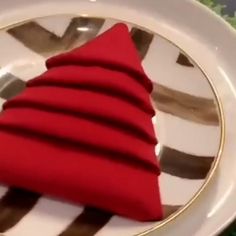 a red christmas tree sitting on top of a white plate