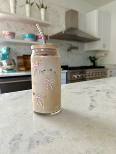 a jar with a straw in it sitting on top of a counter