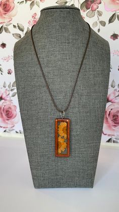 This 16 inch necklace is made with a briwn braided faux leather strand. The pendant is a brown wooden rectangle open bezel, this measures approximately 2.5 inches tall x 2 inches wide.  The wood pendant has a real dried flower in clear UV resin. I enjoy making these pieces and I get better and better with every pour and design. Hope you like my mini work of art!! Although I have made jewelry before using semi-precious stones and metals, basically costume jewelry, and I recently started making the resin jewelry with real dried flowers, I really wanted to up my game by incorporating both styles.  So far I'm loving it! Wood Resin Necklace, 16 Inch Necklace, Peach Flowers, Bezel Pendant, Resin Necklace, Wood Resin, Wood Pendant, Uv Resin, Dried Flower