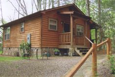 a log cabin in the woods with stairs leading up to it