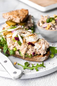 an open face sandwich with chicken salad on toasted bread