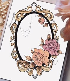 a close up of a card with flowers and pearls on the table next to it